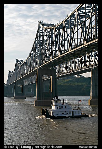 Tugboat under brige on Mississippi River. Natchez, Mississippi, USA