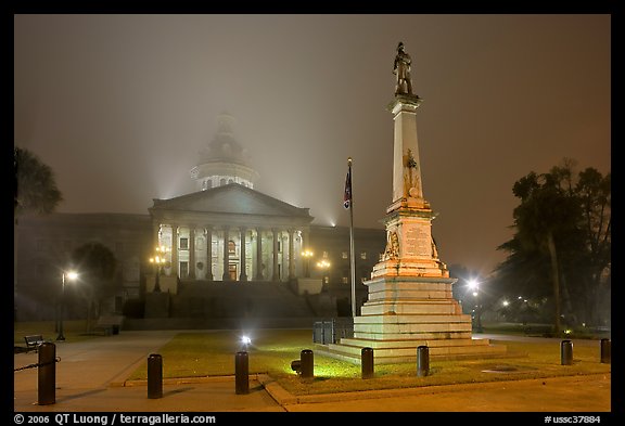 Monument to Confederate soldiers and state capitol at night. Columbia, South Carolina, USA