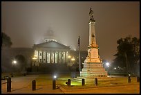 Monument to Confederate soldiers and state capitol at night. Columbia, South Carolina, USA (color)