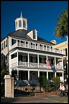 Couple walking in front of antebellum house. Charleston, South Carolina, USA