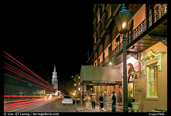 Street, church, and Mills house hotel with many guests at night. Charleston, South Carolina, USA