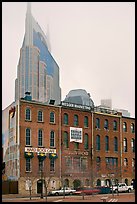 Row of brick buildings and Bell South Tower in fog. Nashville, Tennessee, USA (color)