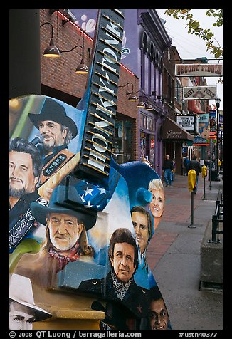 Guitar-shaped sign with images of famous singers on Broadway sidewalk. Nashville, Tennessee, USA