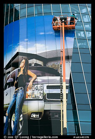 Workers pasting mural-sized car advertising on building. Nashville, Tennessee, USA