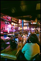 Patrons listen to musical performance in Beale Street bar. Memphis, Tennessee, USA (color)