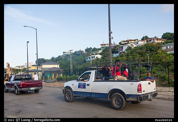 Residents riding in back of pick-up trucks, Cruz Bay. Saint John, US Virgin Islands (color)