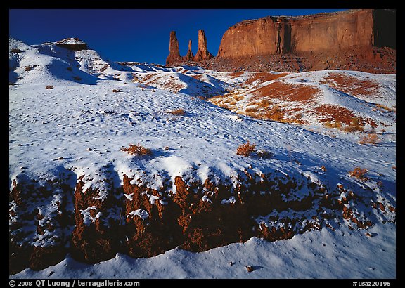 Snow on the floor, with Three Sisters in the background. Monument Valley Tribal Park, Navajo Nation, Arizona and Utah, USA (color)