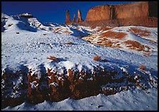 Snow on the floor, with Three Sisters in the background. Monument Valley Tribal Park, Navajo Nation, Arizona and Utah, USA (color)