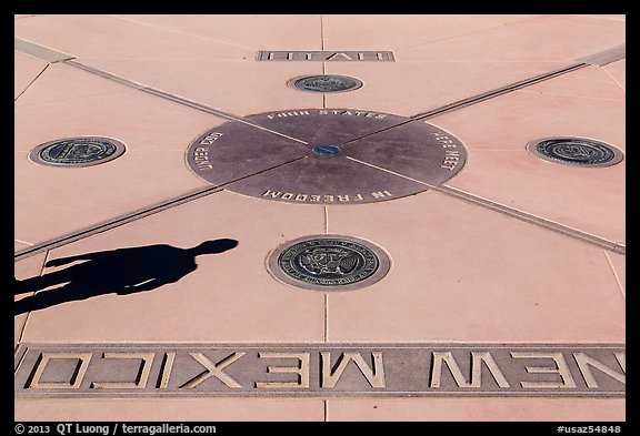 Shadow and state seals. Four Corners Monument, Arizona, USA