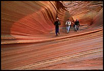 Hikers walk out of the Wave. Coyote Buttes, Vermilion cliffs National Monument, Arizona, USA (color)