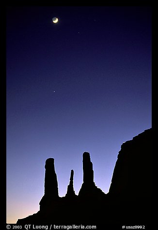 Three sisters and moon, dusk. Monument Valley Tribal Park, Navajo Nation, Arizona and Utah, USA