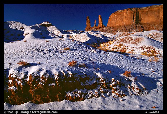 Snow on the floor, with Three Sisters in the background. Monument Valley Tribal Park, Navajo Nation, Arizona and Utah, USA (color)