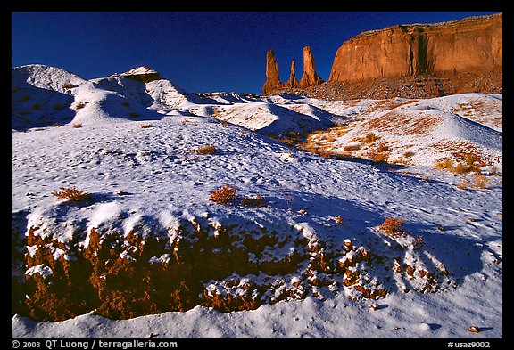 Snow on the floor, with Three Sisters in the background. Monument Valley Tribal Park, Navajo Nation, Arizona and Utah, USA