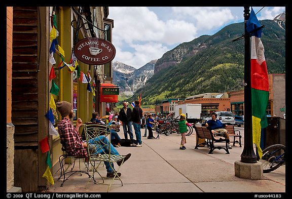 Men sitting on main street sidewalk. Telluride, Colorado, USA (color)