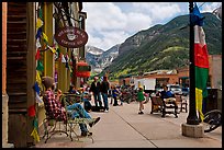 Men sitting on main street sidewalk. Telluride, Colorado, USA