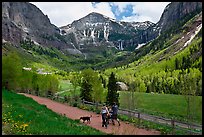 Family hiking on trail towards Bridalveil Falls in the spring. Telluride, Colorado, USA