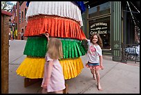 Girls spin tibetan prayer wheel. Telluride, Colorado, USA ( color)