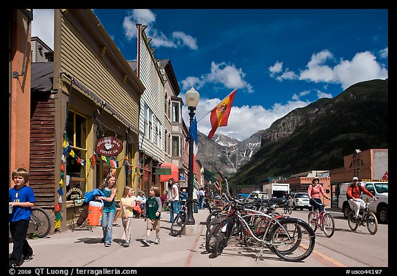 Children walking on main street past mountain bikes. Telluride, Colorado, USA (color)