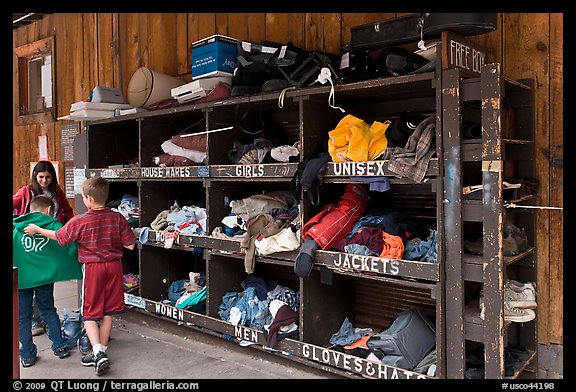 Family tries out clothes from sharing box. Telluride, Colorado, USA