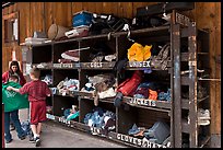 Family tries out clothes from sharing box. Telluride, Colorado, USA (color)