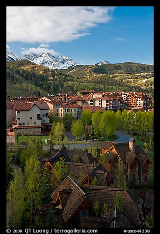 Mountain Village with newly leafed spring trees and snowy peaks. Telluride, Colorado, USA (color)