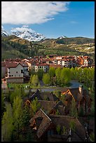 Mountain Village with newly leafed spring trees and snowy peaks. Telluride, Colorado, USA