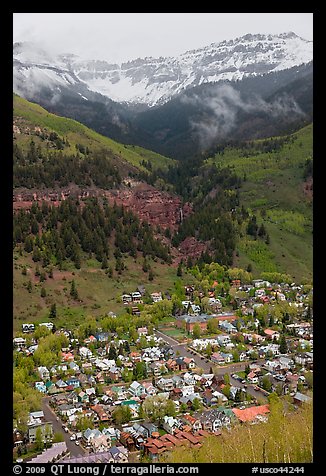 Town, waterfall, and snowy mountains in spring. Telluride, Colorado, USA