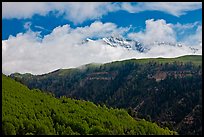 Snowy Mt Wilson emerging from clouds in the spring. Colorado, USA