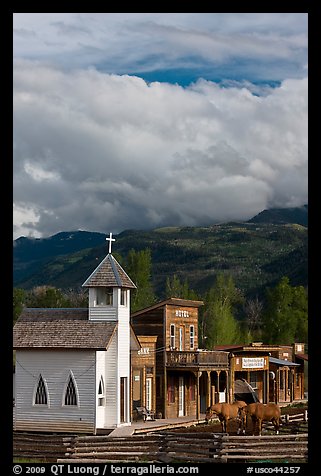 Horses grazing in front of historic-looking buildings, Ridgeway. Colorado, USA