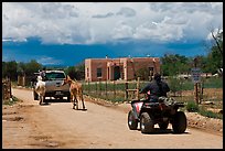 Rural road on the reservation with ATV, truck and horse. Taos, New Mexico, USA (color)