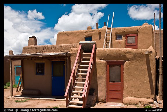 Multi-story pueblo houses with ladders. Taos, New Mexico, USA (color)