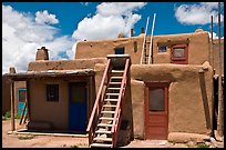 Multi-story pueblo houses with ladders. Taos, New Mexico, USA