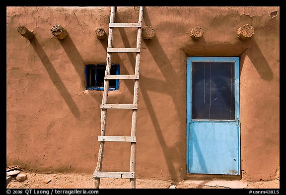 Ladder on adobe facade. Taos, New Mexico, USA