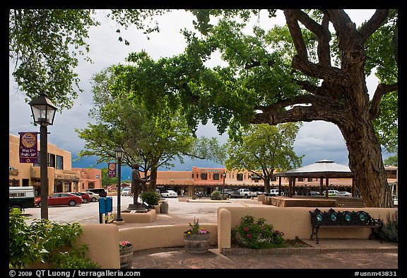 Plazza, trees and buildings in adobe style. Taos, New Mexico, USA (color)