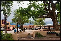 Plazza, trees and buildings in adobe style. Taos, New Mexico, USA (color)