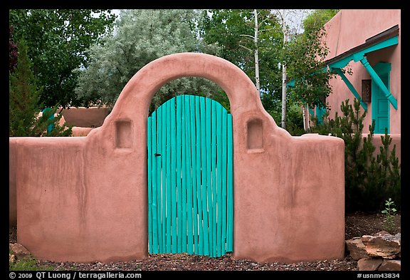 Blue door and adobe yard wall. Taos, New Mexico, USA