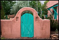 Blue door and adobe yard wall. Taos, New Mexico, USA (color)