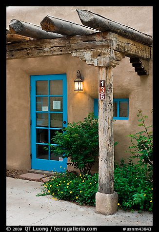 Blue door and window at house entrance. Taos, New Mexico, USA