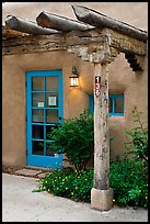 Blue door and window at house entrance. Taos, New Mexico, USA