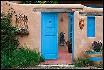 Adobe style walls, blue doors and windows, and courtyard. Taos, New Mexico, USA (color)