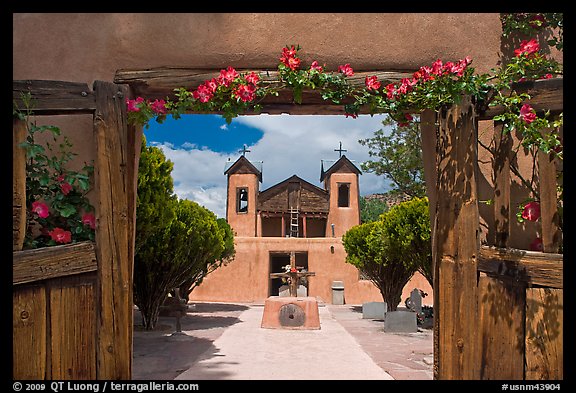 Church framed by doors with roses, Sanctuario de Chimayo. New Mexico, USA (color)