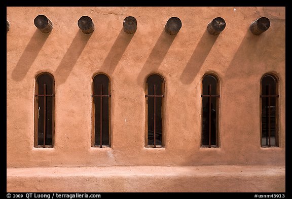 Facade with vigas (heavy timbers) extending through walls to support roof, Chimayo sanctuary. New Mexico, USA