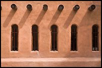 Facade with vigas (heavy timbers) extending through walls to support roof, Chimayo sanctuary. New Mexico, USA