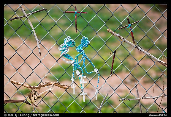 Chain-link fence with rosaries and improvised crosses, Sanctuario de Chimayo. New Mexico, USA