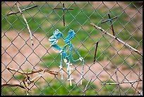 Chain-link fence with rosaries and improvised crosses, Sanctuario de Chimayo. New Mexico, USA