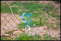 Chain-link fence with rosaries and improvised crosses, Sanctuario de Chimayo. New Mexico, USA ( color)