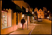 Man walking gallery and St Francis by night. Santa Fe, New Mexico, USA (color)