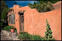 Adobe wall and weathered wooden door and window. Santa Fe, New Mexico, USA ( color)