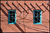 Detail of art installation on facade of adobe building. Santa Fe, New Mexico, USA