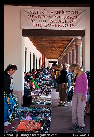 Tourists browse wares sold under native american vendors program of the palace of the governors. Santa Fe, New Mexico, USA (color)